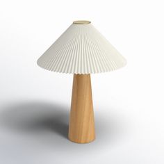 a white table lamp sitting on top of a wooden base