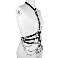 Babe Chains Harness Belt A stunning full body harness bra with built-in choker collar and decorative belt chains. This beautiful body harness features a long vertical strap from the choker neck, and triple metal chains draped under the waist. A gorgeous silhouette is formed from the chest to waist straps, with adjustable buckles and killer metal O-ring hardware and rivet studs. One Adjustable Size. Material: Vegan Faux Leather. Thigh Harness Outfit, Body Harness Jewelry, Harness Jewelry, Belt Chains, Harness Outfit, Full Body Harness, Thigh Harness, Chain Harness, Harness Belt