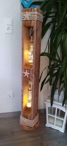 a tall wooden shelf with lights inside of it