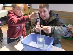 a man teaching a child how to use a beakle