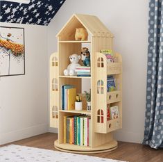 a wooden doll house with bookshelf and stuffed animals on the shelf next to it