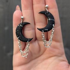 Celestial crescent moon earrings for the dark souls. Crafted from polymer clay and silver-plated findings with a delicate double chain embellishment, these dangles are the ideal witchy gift for a Goddess in your life (that includes you). COLOUR: Black/Silver MATERIALS: Polymer Clay/Silver-Plated Ball Posts, Chain & Jump Rings Handmade from Polymer Clay making them lightweight and durable. If you have any questions, please do reach out and I will answer you ASAP. Mystic Clay Designs operates a no Goth Clay Earrings, Moon Jewellery, Boho Witch, Crescent Moon Jewelry, Clay Studs, Witchy Gifts, Clay Silver, Clay Making, Clay Designs