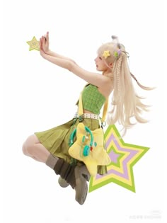 a woman in a green dress is flying through the air with a star shaped object