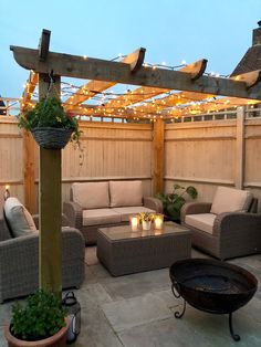 an outdoor living area with couches, chairs and lights on the roof above it