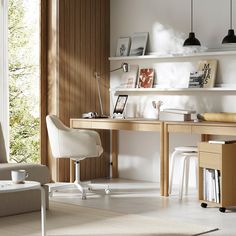 a white chair sitting in front of a desk next to a wall mounted book shelf