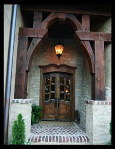 an entrance to a home with brick and wood