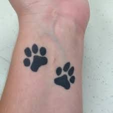 two black paw prints on the wrist