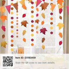 an image of fall decorations hanging from the window with qr code to see them details