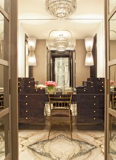 an elegant dining room with marble flooring and chandelier