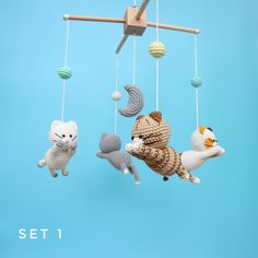 three crocheted animals hanging from strings in front of a blue background with the words set 1 written below them