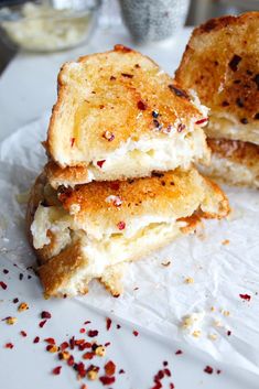 two pieces of bread sitting on top of a white paper towel covered in crumbs