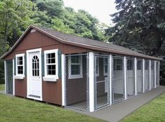 a small red and white shed with windows