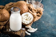 a bottle of milk next to some coconuts