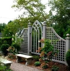 a garden area with a bench and trellis