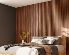 a bed sitting in a bedroom next to a wooden wall with vertical slats on it