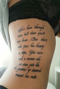 the back of a man's arm with words on it and an inscription in black ink