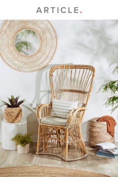 a wicker chair sitting on top of a wooden floor next to a potted plant