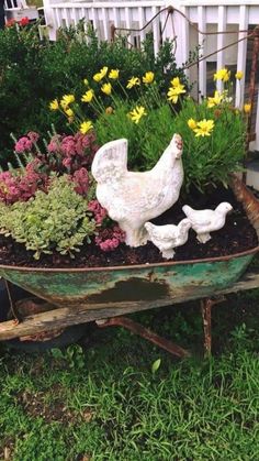 a wheelbarrow filled with flowers and chickens