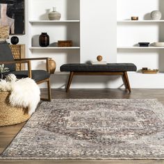 a living room filled with furniture and a large rug on top of a hard wood floor