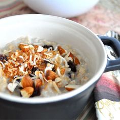 a bowl of oatmeal with nuts and raisins