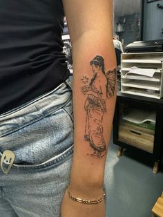 a woman with a tattoo on her arm