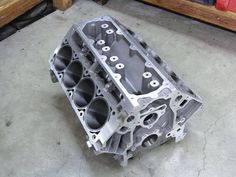 an engine block sitting on the ground in a garage