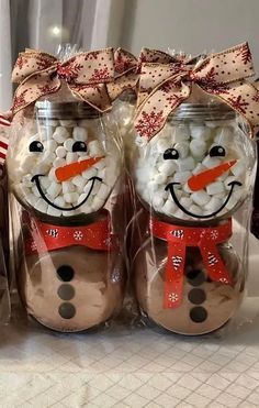 three jars filled with marshmallows in the shape of snowmen