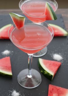 two glasses filled with watermelon and garnished with sugar