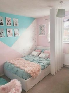 a bed room with a neatly made bed and pictures on the wall