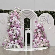 a white and pink floral display with arches