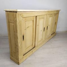 a large wooden cabinet sitting on top of a white floor