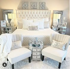 a bedroom with white bedding and silver accents