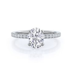 a round brilliant cut diamond ring with pave set shoulders