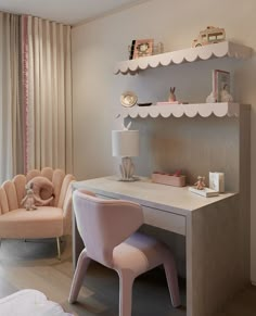 a baby's room with a desk, chair and shelves