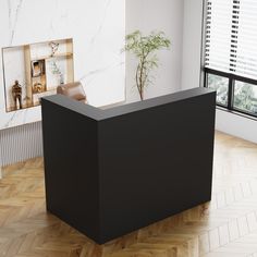 a black reception table sitting on top of a hard wood floor next to a window