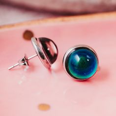 Remember when you were young and you wore the mood rings? Okay maybe I am showing my age here but those were fun! Here we have a pair of stud earrings with the same mood color changing concept. Minimalist style post studs in silver color. Studs are made of stainless steel with a butterfly backer. 12mm in diameter - round circle shape. Nice pair of earrings for everyday wear during the summer (or any time really) that will change colors due to the temperature. Colors vary from a dark blue to a ye Mood Rings, Mood Jewelry, Mood Colors, Mood Ring, Earring Cards, Round Circle, Remember When, Circle Shape, Matching Necklaces