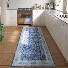 a large blue rug in the middle of a kitchen