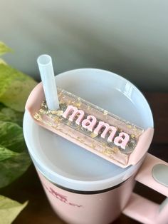 there is a pink cup with a straw in it and the word mama on top