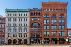 an old brick building with many windows on the front and side of it's sides