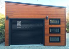 a wooden garage with three windows on the side