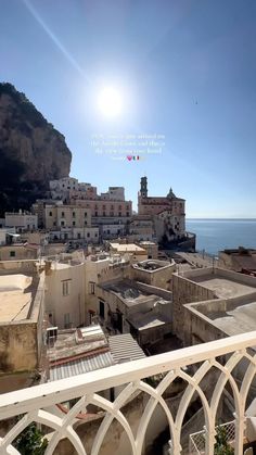 the sun shines brightly over an old town by the ocean in italy, on a sunny day