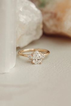 a diamond ring sitting on top of a table