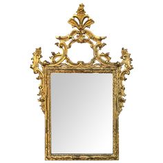 an ornate gold framed mirror against a white background