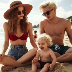 a man and woman sitting on the beach with a small child in front of them