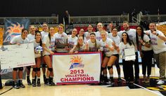 the volleyball team is posing with their trophy