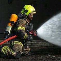 a firefighter is spraying water on the floor