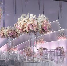 the tables are set with white and pink flowers