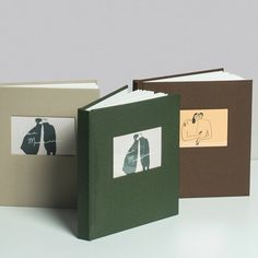 three different colored books with pictures on them