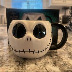 a coffee mug that has been decorated to look like jack skellingy