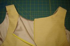 the back of a yellow dress being made